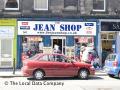 The Jean Shop logo