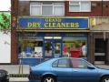 Grand Dry Cleaners logo