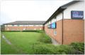 Travelodge Warrington Lymm Services logo