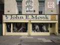 John E Monk logo