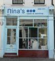 Nina's Nails & Tanning logo